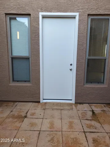 an empty room with windows and closet