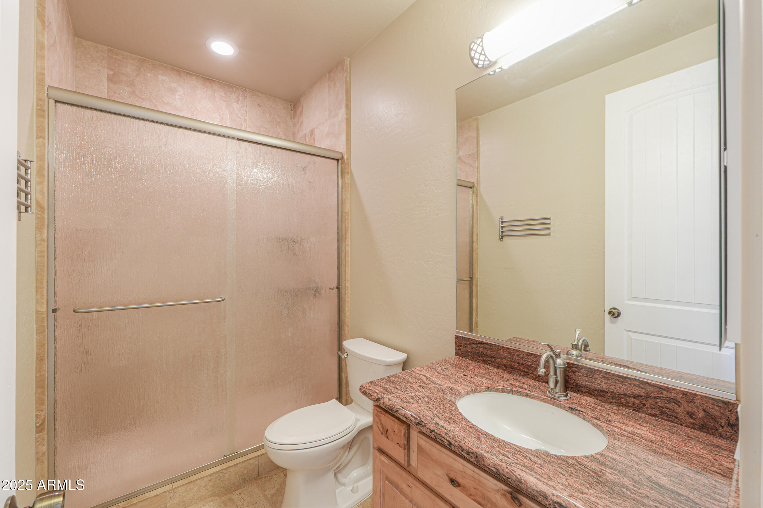 53304 West Barnes Road Maricopa, AZ 85139 - Photo 19 of 75 a bathroom with a granite countertop sink toilet and a mirror