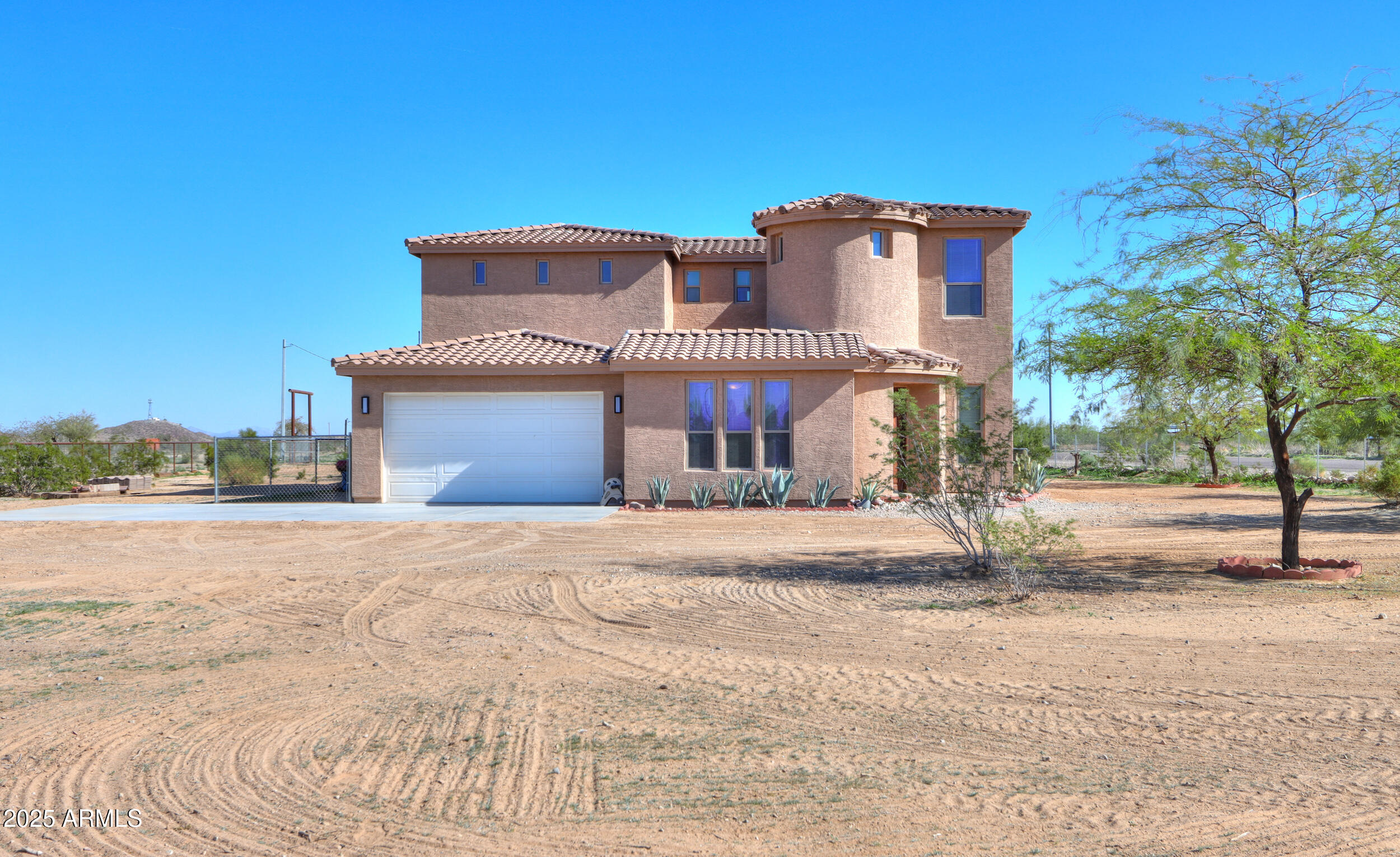 53304 West Barnes Road Maricopa, AZ 85139 - Photo 2 of 75 a front view of a house with a yard and garage