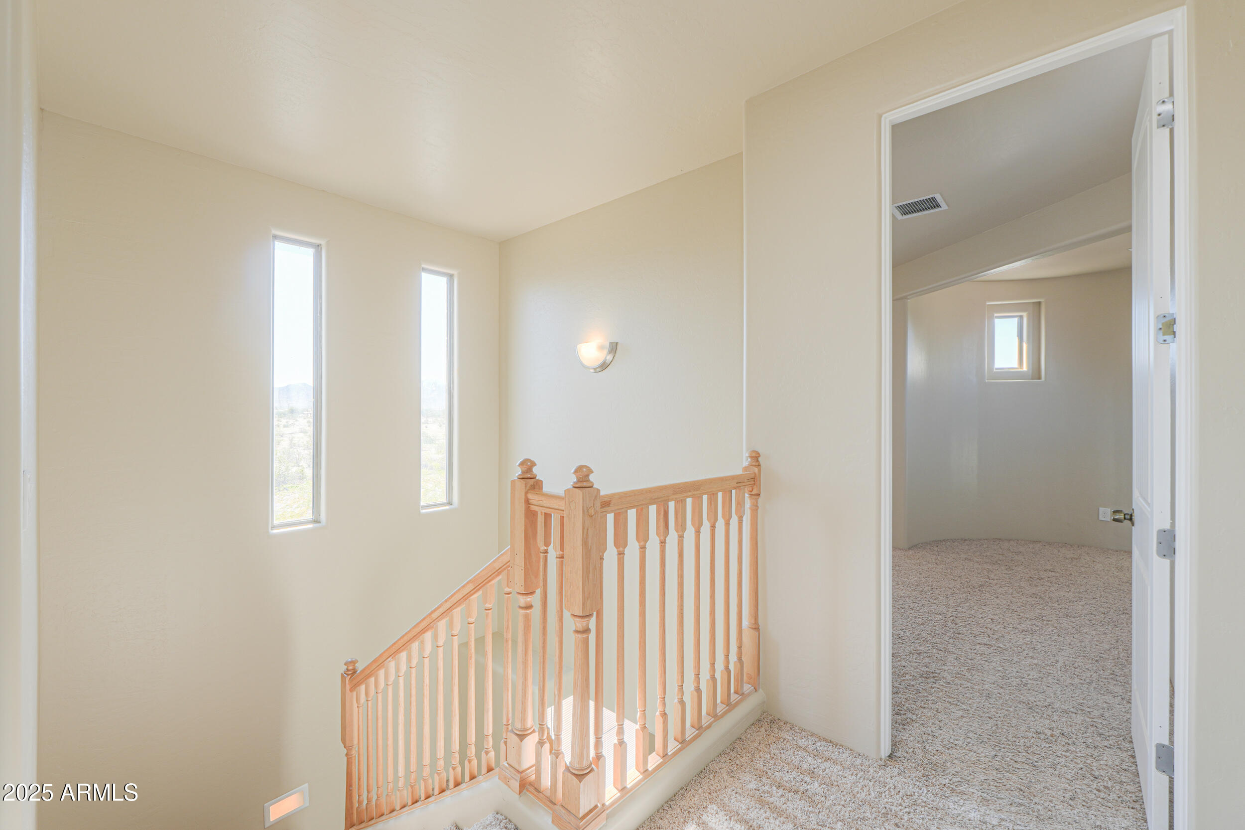53304 West Barnes Road Maricopa, AZ 85139 - Photo 22 of 75 a view of a hallway with a window and stairs