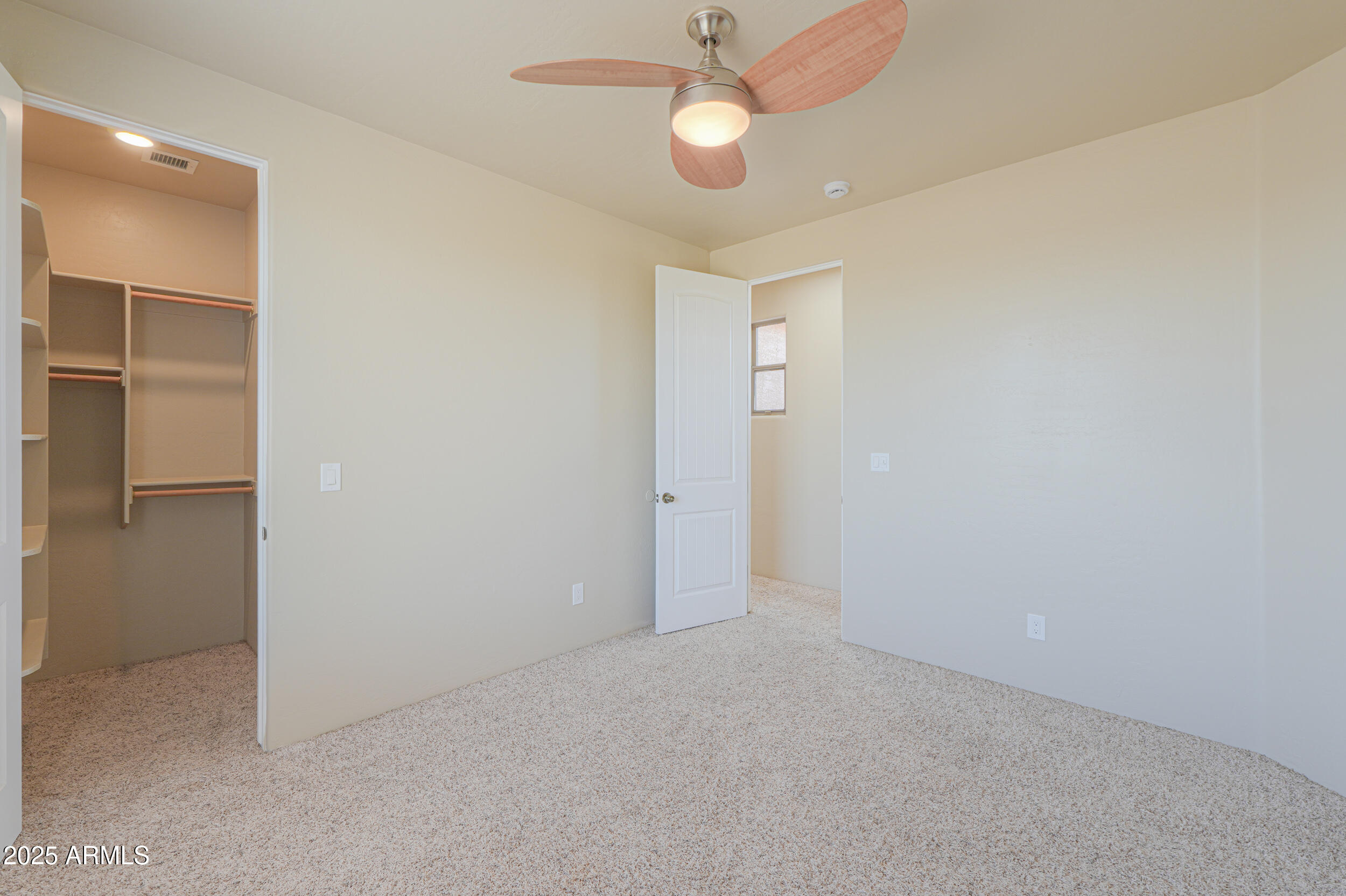 53304 West Barnes Road Maricopa, AZ 85139 - Photo 30 of 75 an empty room with a ceiling fan and a ceiling fan
