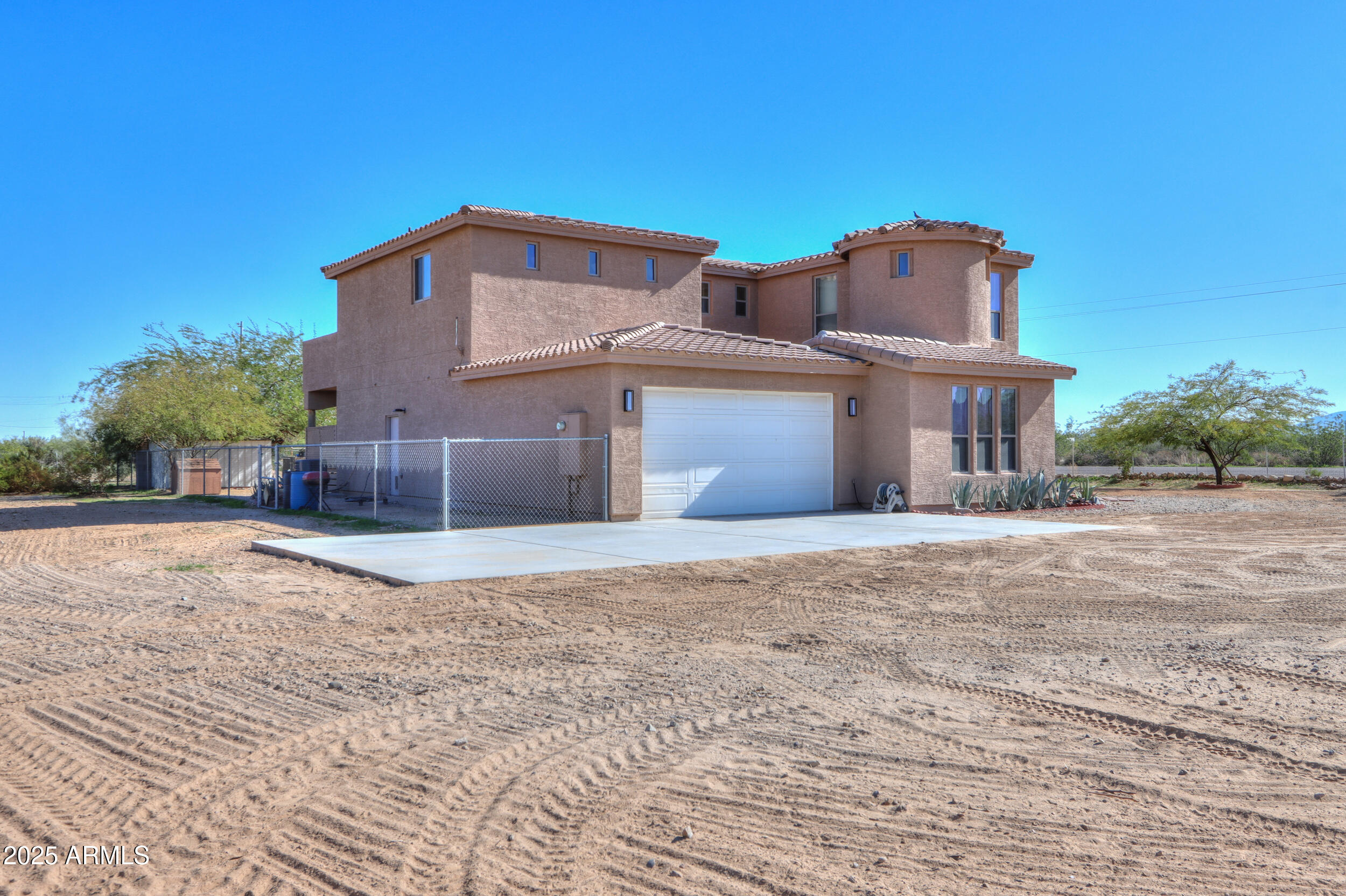 53304 West Barnes Road Maricopa, AZ 85139 - Photo 3 of 75 a front view of a house with a yard and garage