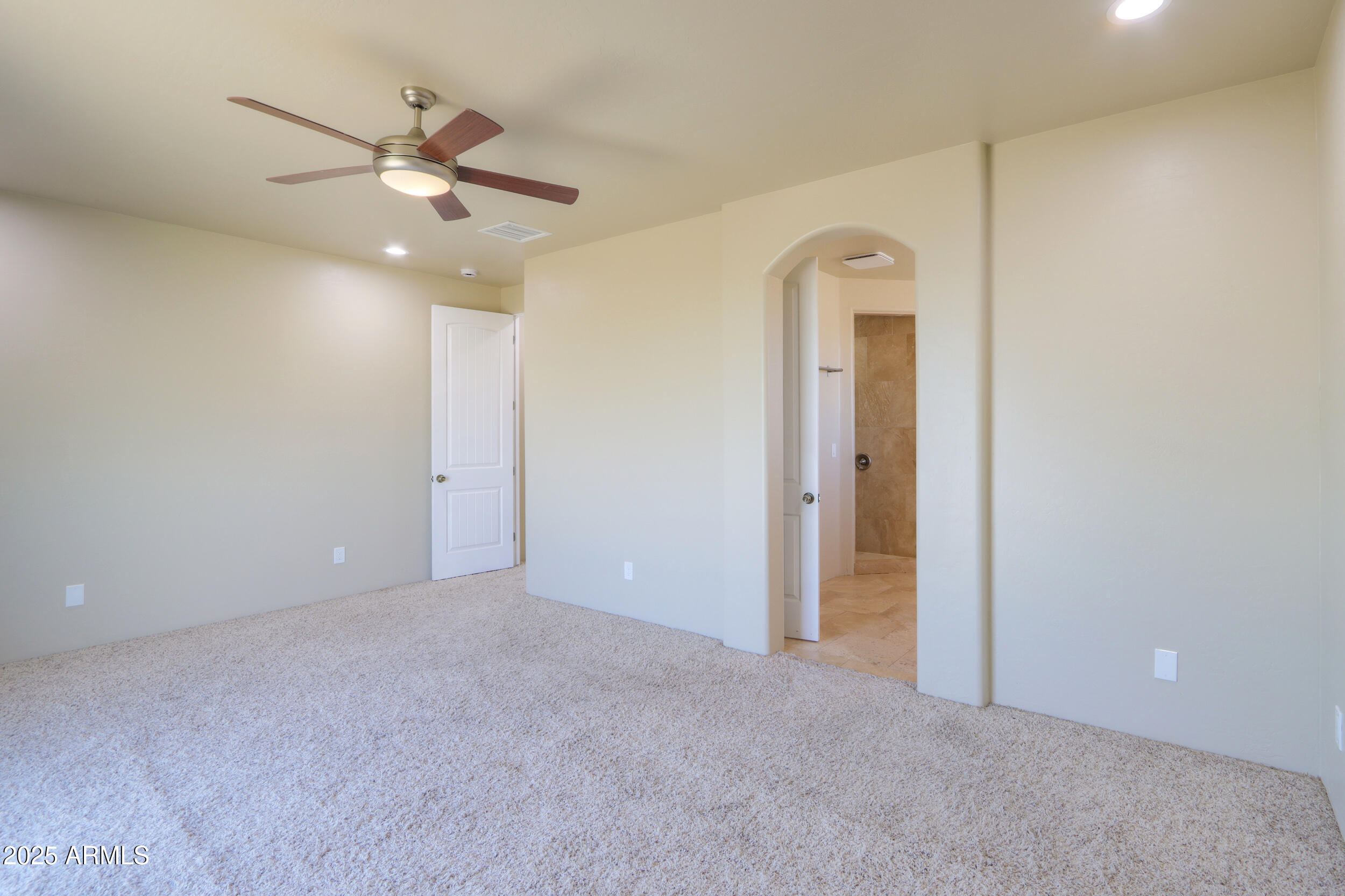 53304 West Barnes Road Maricopa, AZ 85139 - Photo 32 of 75 an empty room with a ceiling fan and a window