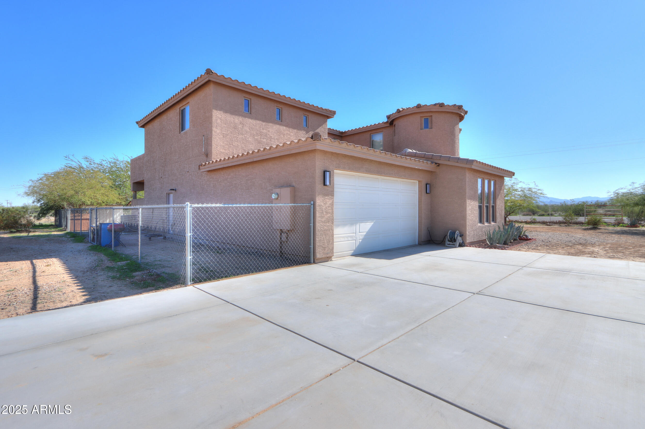 53304 West Barnes Road Maricopa, AZ 85139 - Photo 48 of 75 a front view of a house with a yard and garage