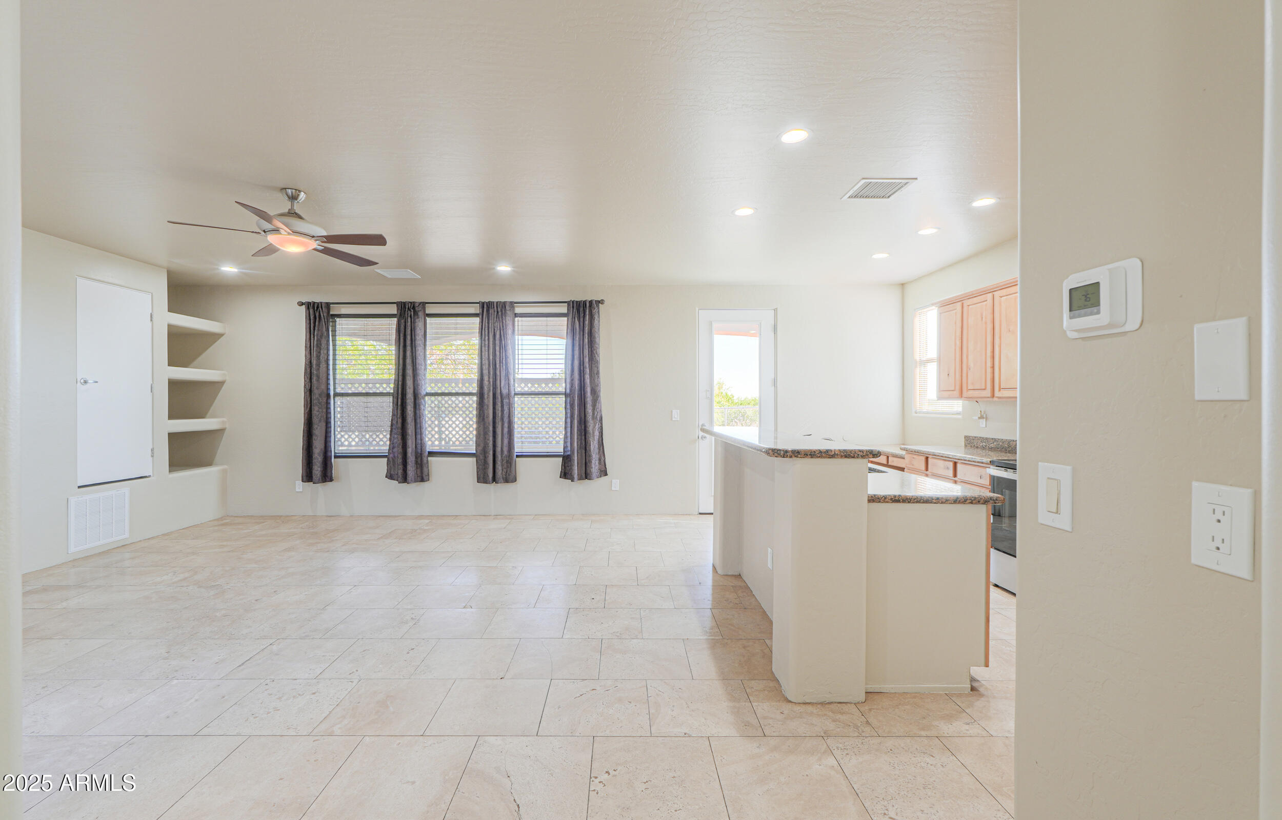 53304 West Barnes Road Maricopa, AZ 85139 - Photo 9 of 75 a view of a kitchen with furniture and a ceiling fan