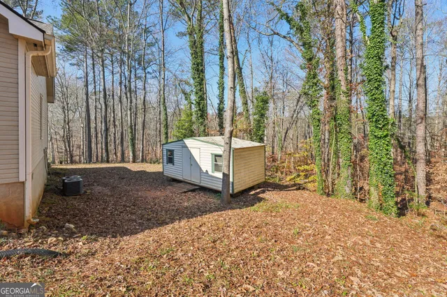 a picture of a room with a white wall and a white refrigerator