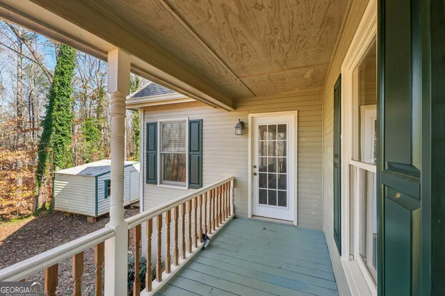 a view of a patio with table and chairs and wooden floor