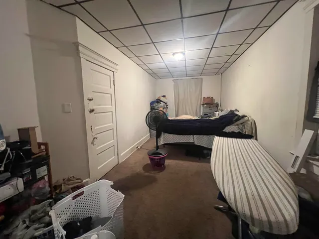 a bed room with a bed a television and a desk