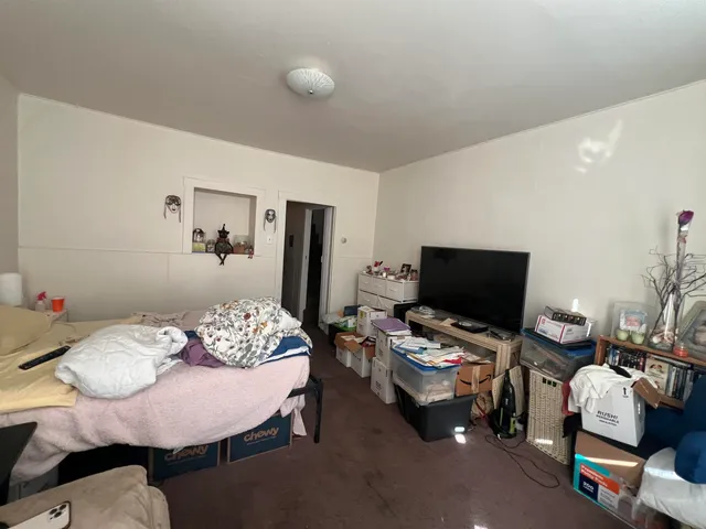 a bedroom with furniture and a flat screen tv