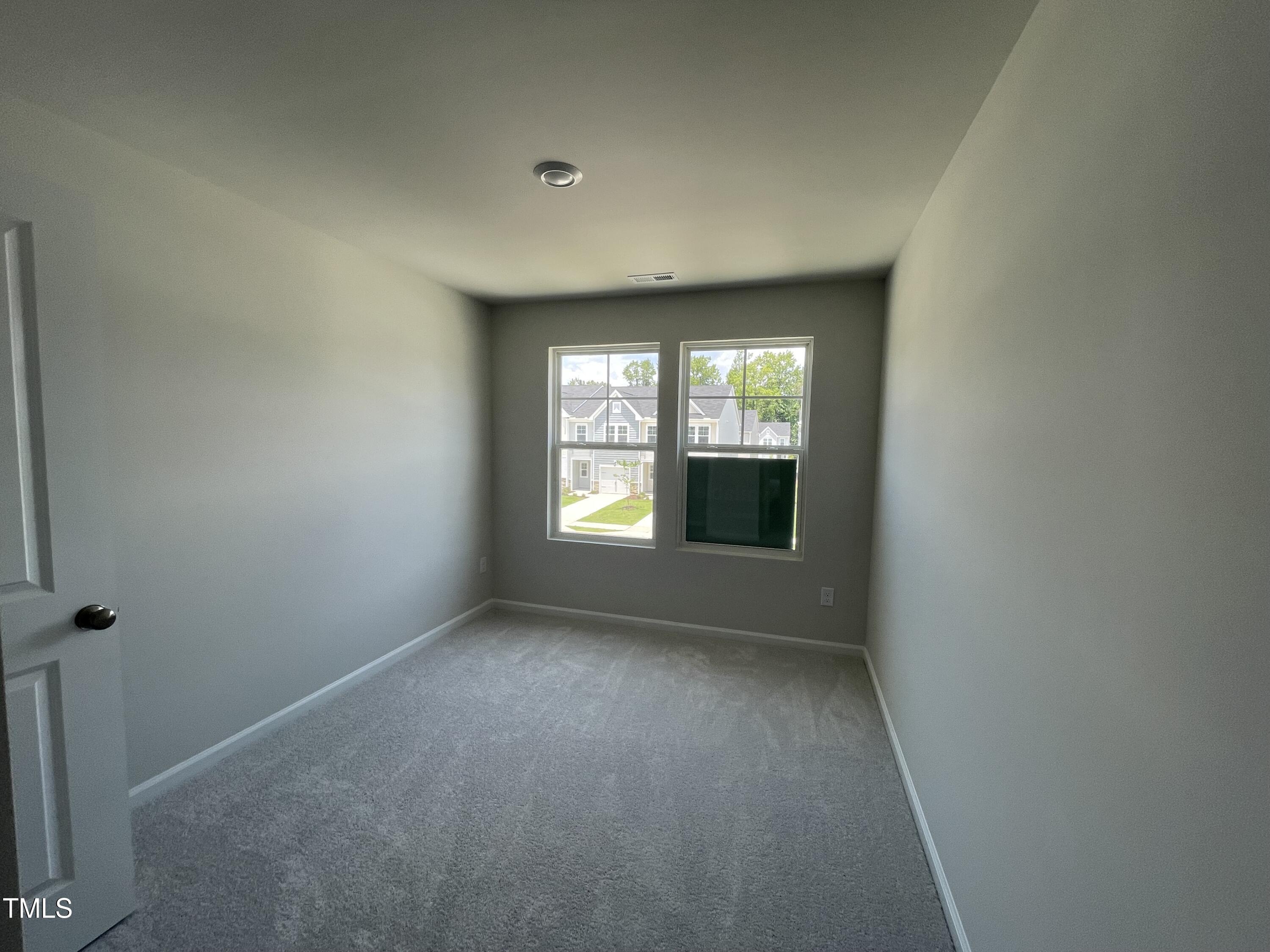 244 Paramount Drive Smithfield, NC 27577 - Photo 8 of 43 an empty room with windows
