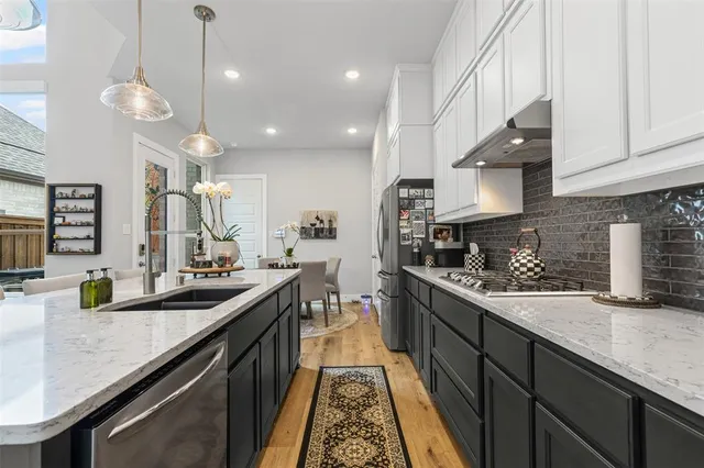 a kitchen with refrigerator a sink and cabinets