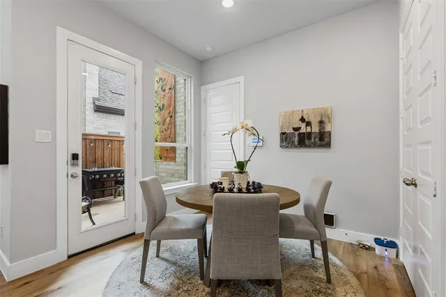 a kitchen with stainless steel appliances granite countertop a sink a stove a refrigerator cabinets and chairs