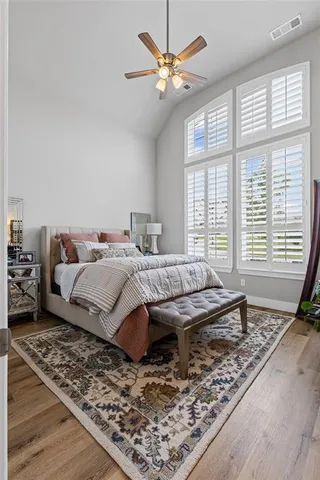 a bedroom with a bed and wooden floor