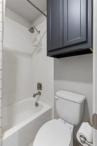 a bedroom with a bed and a lamp