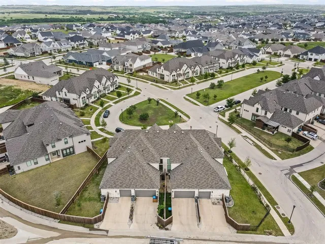 an aerial view of a swimming pool with outdoor seating