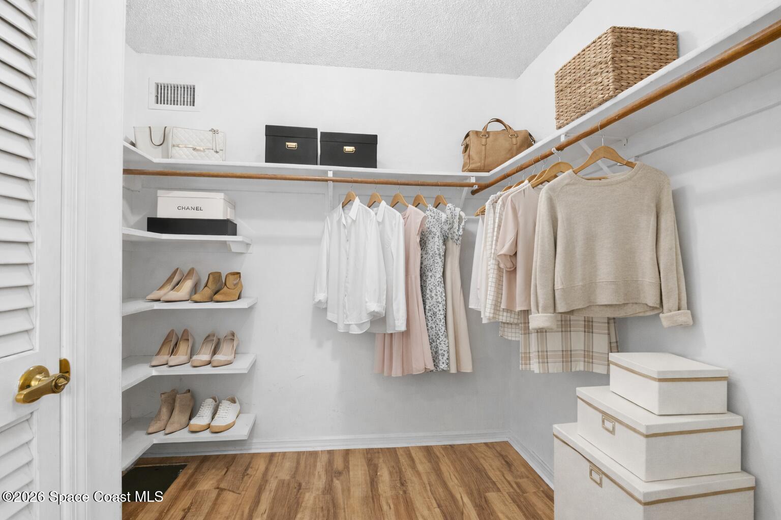 835 Sunswept Road Northeast Palm Bay, FL 32905 - Photo 11 of 36 a view of walk in closet with clothes and shoes