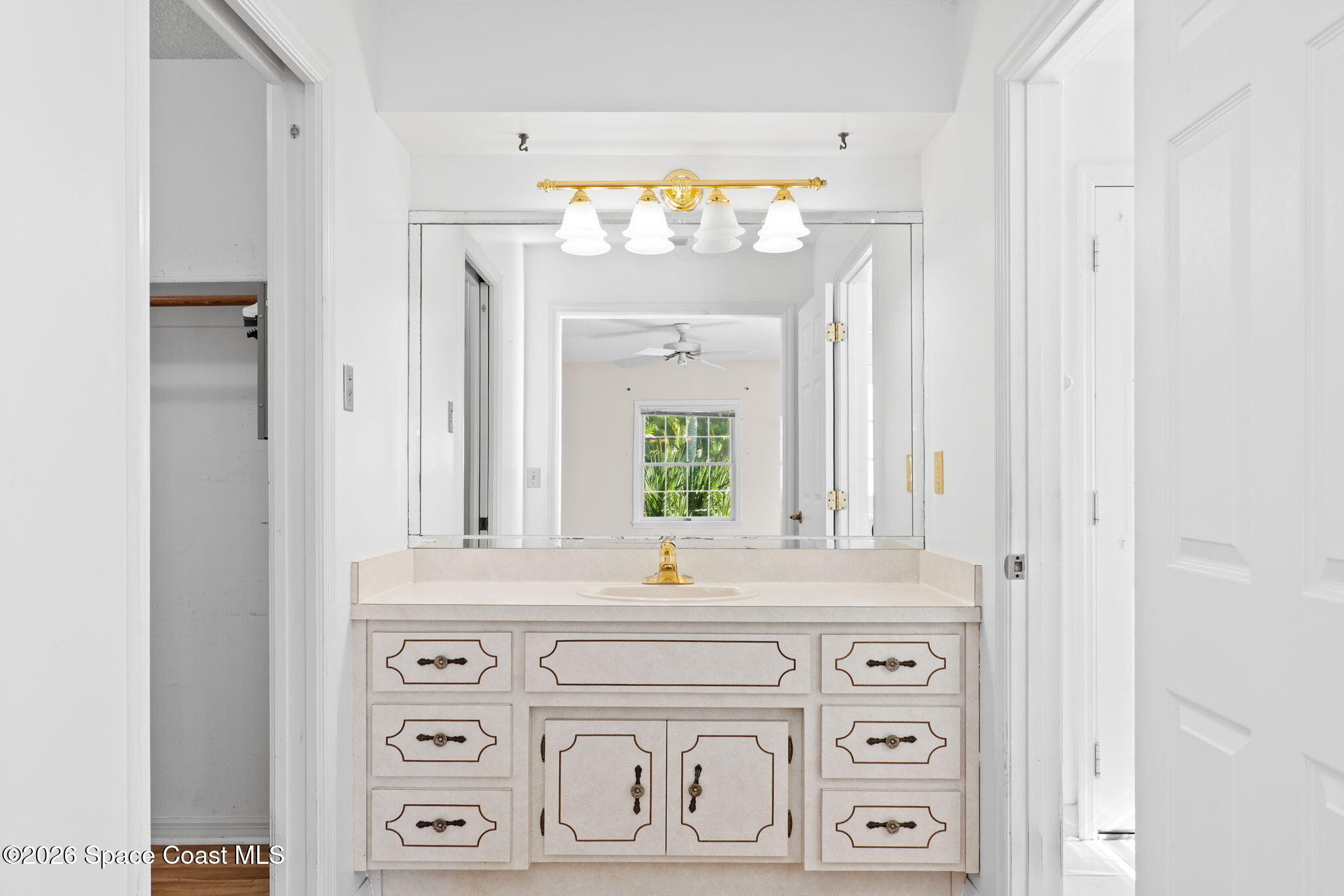 835 Sunswept Road Northeast Palm Bay, FL 32905 - Photo 12 of 36 a bathroom with a sink and a mirror