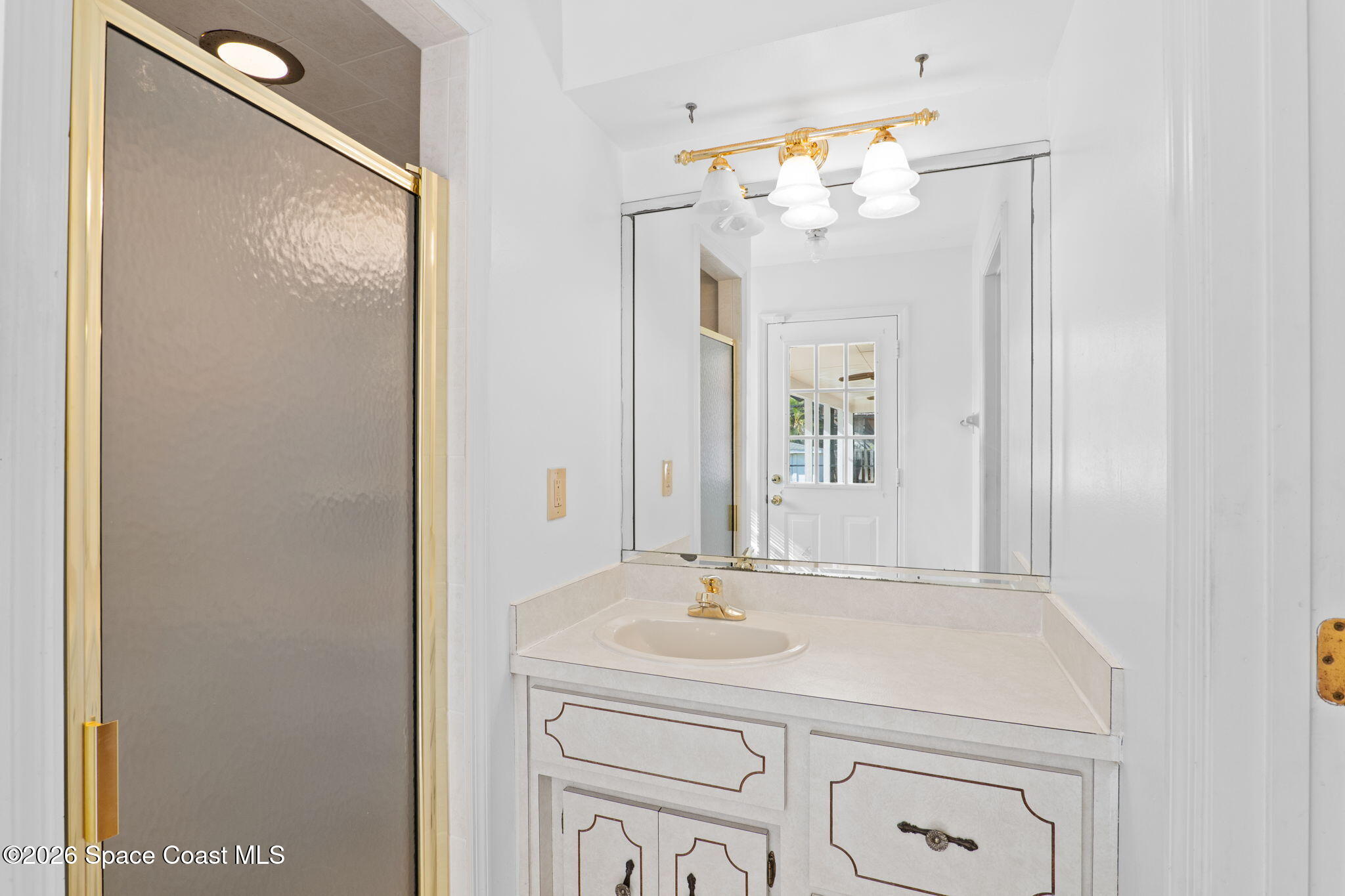 835 Sunswept Road Northeast Palm Bay, FL 32905 - Photo 13 of 36 a bathroom with a sink vanity and a mirror