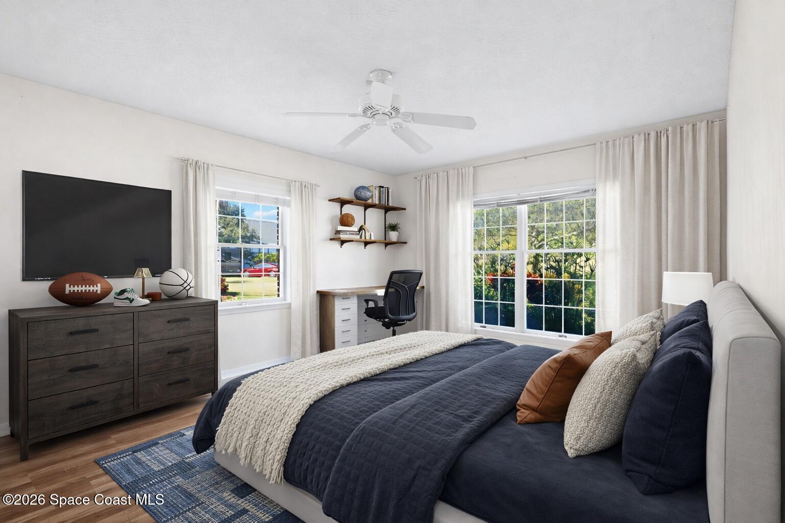 835 Sunswept Road Northeast Palm Bay, FL 32905 - Photo 14 of 36 a bedroom with a bed and a flat screen tv