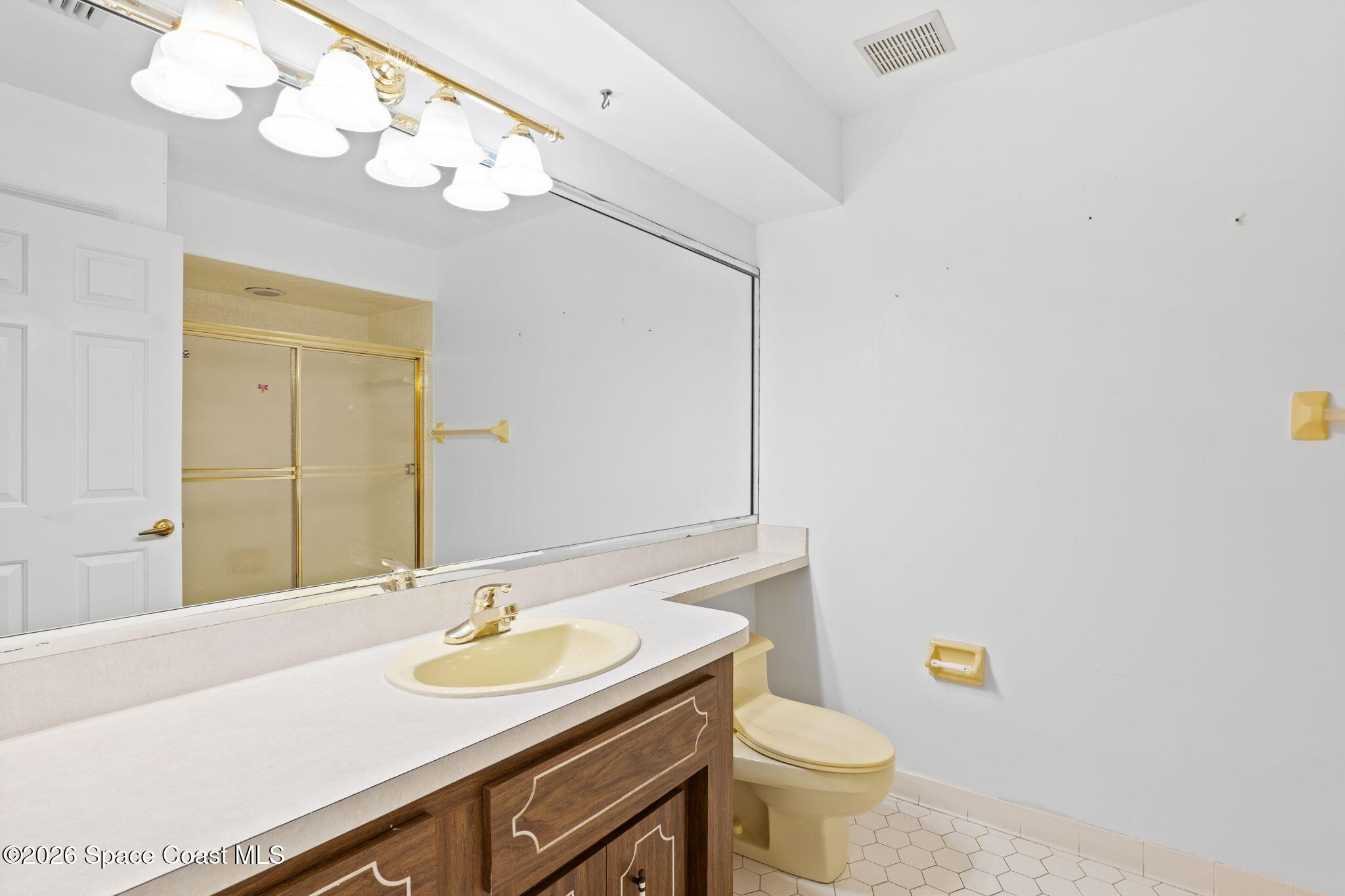 835 Sunswept Road Northeast Palm Bay, FL 32905 - Photo 15 of 36 a bathroom with a sink a toilet and a mirror