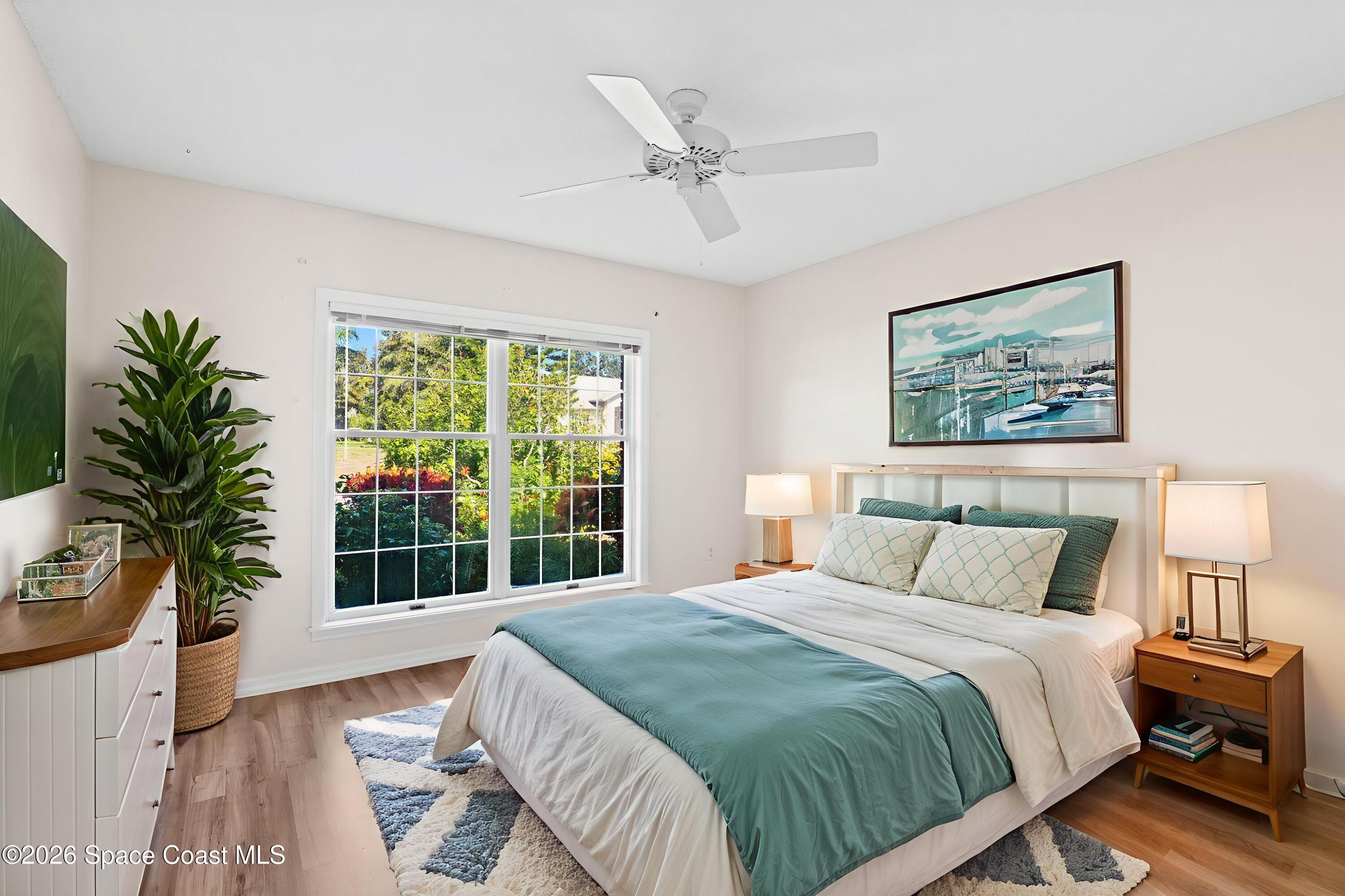 835 Sunswept Road Northeast Palm Bay, FL 32905 - Photo 16 of 36 a bedroom with a large bed and a window