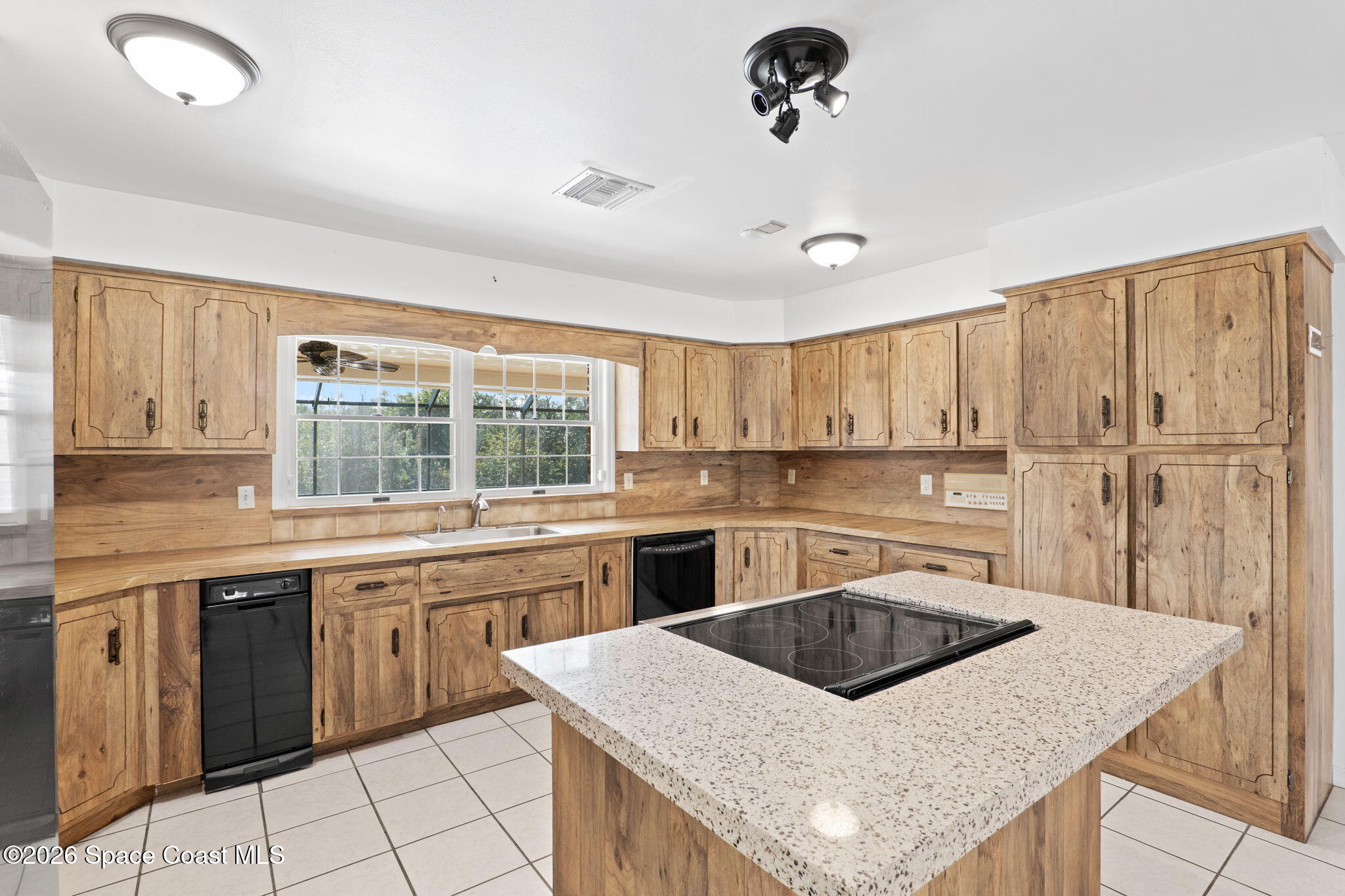 835 Sunswept Road Northeast Palm Bay, FL 32905 - Photo 19 of 36 a kitchen with stainless steel appliances granite countertop a sink stove and refrigerator