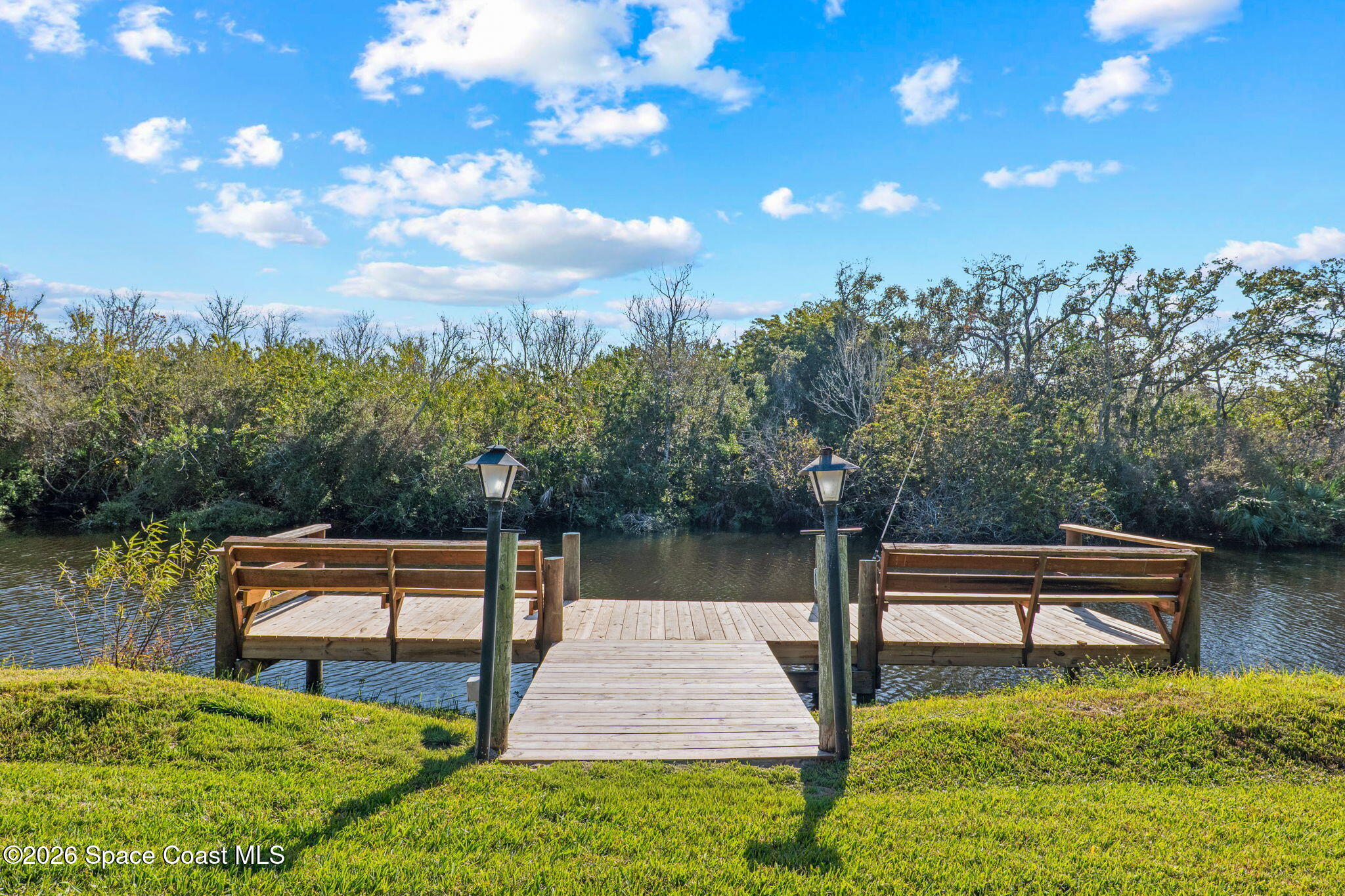 835 Sunswept Road Northeast Palm Bay, FL 32905 - Photo 2 of 36 a backyard of a house with lots of green space and lake view