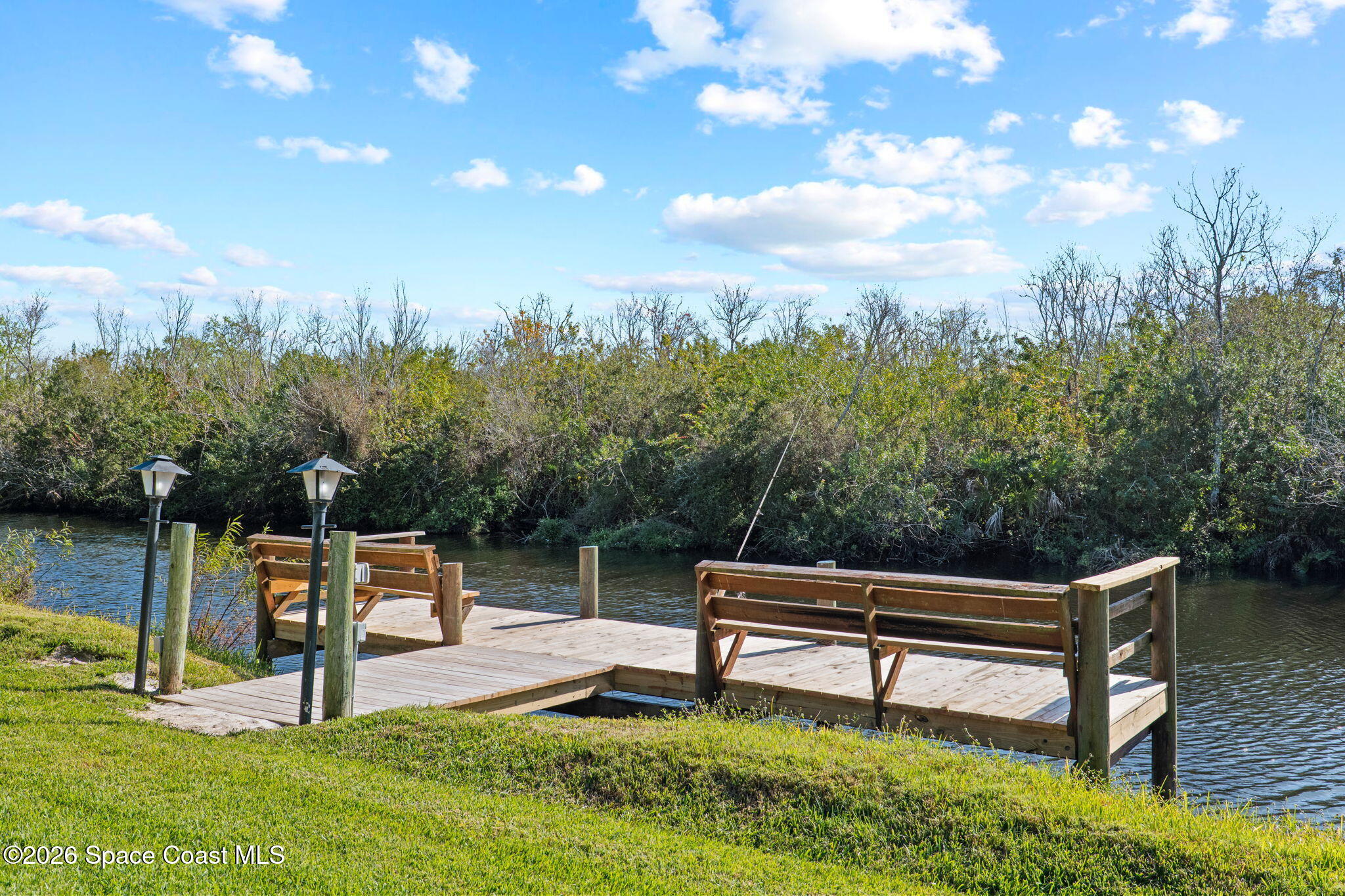 835 Sunswept Road Northeast Palm Bay, FL 32905 - Photo 26 of 36 a park view with a bench in the garden