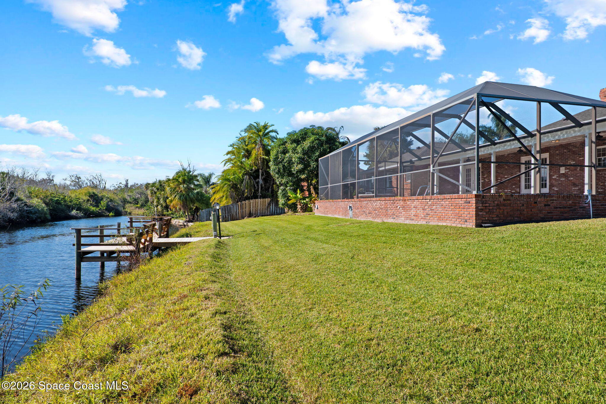835 Sunswept Road Northeast Palm Bay, FL 32905 - Photo 30 of 36 a view of a house with a big yard and potted plants