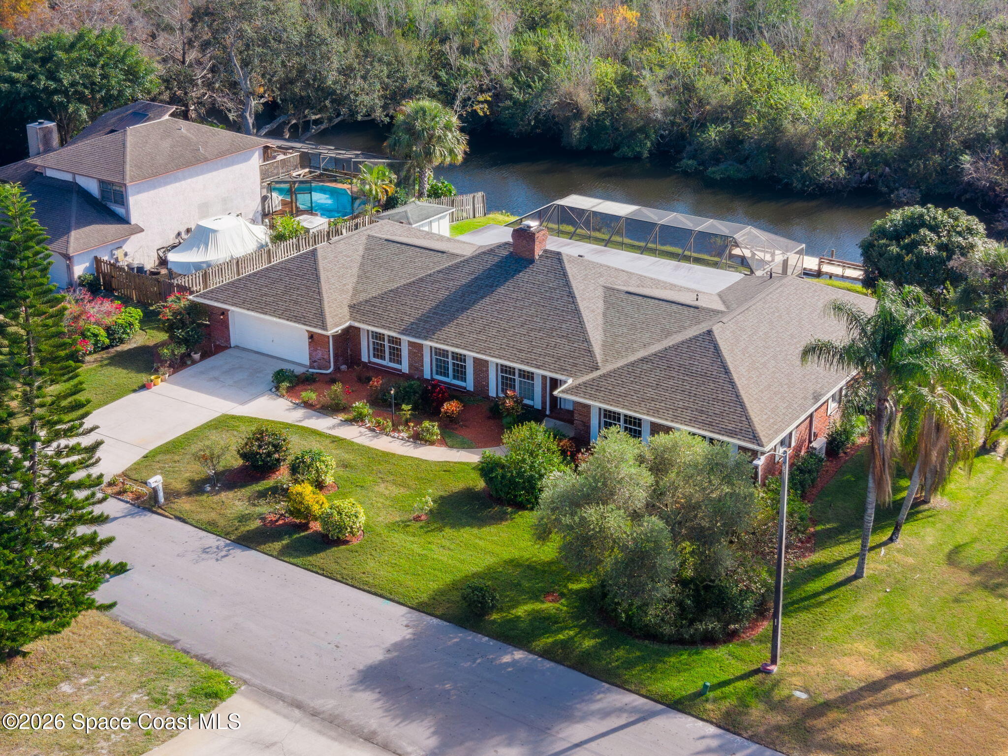 835 Sunswept Road Northeast Palm Bay, FL 32905 - Photo 34 of 36 an aerial view of a house with a garden and lake view