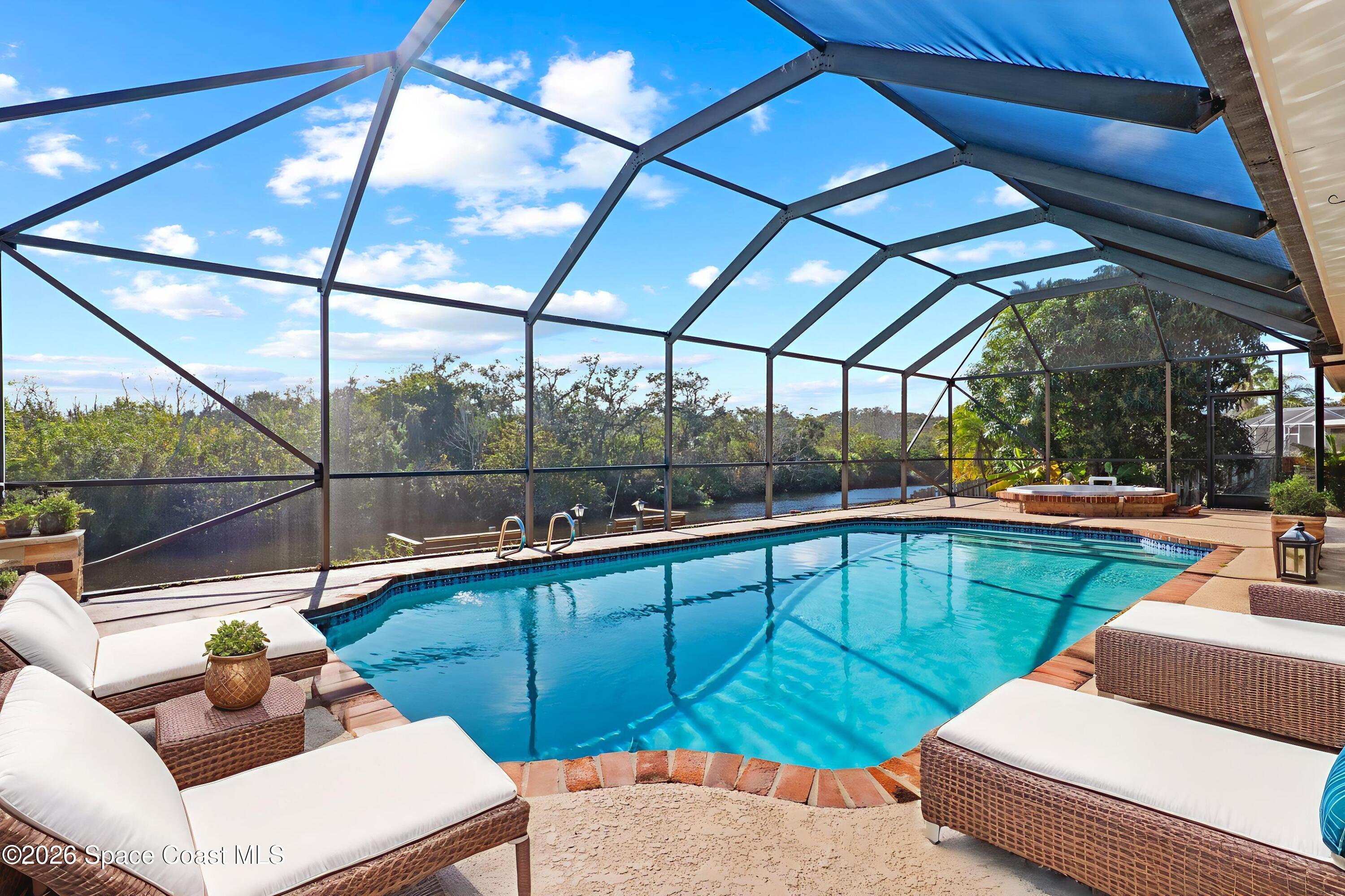 835 Sunswept Road Northeast Palm Bay, FL 32905 - Photo 5 of 36 a view of a patio with a table and chairs