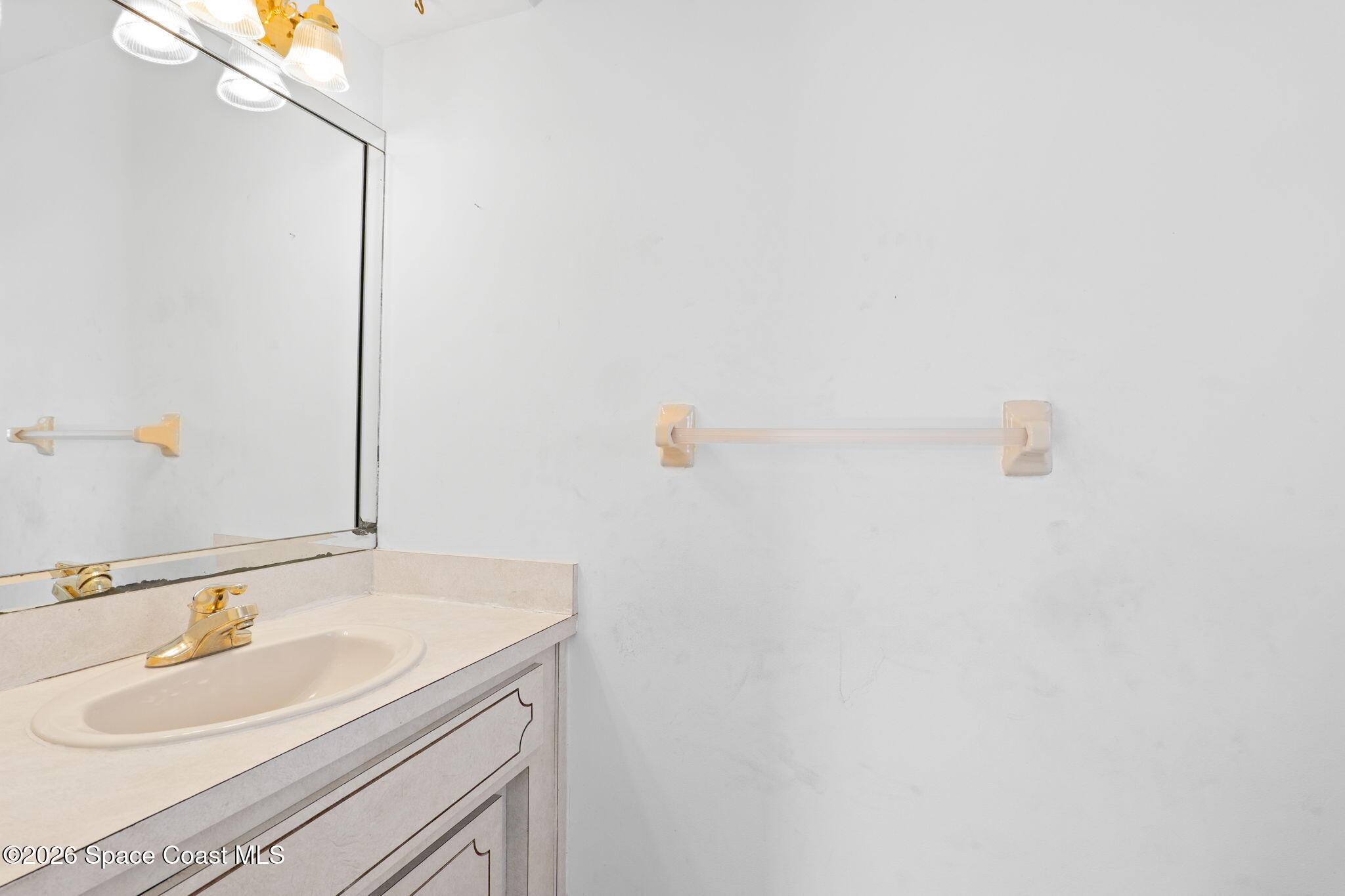 835 Sunswept Road Northeast Palm Bay, FL 32905 - Photo 8 of 36 a bathroom with a sink and a mirror