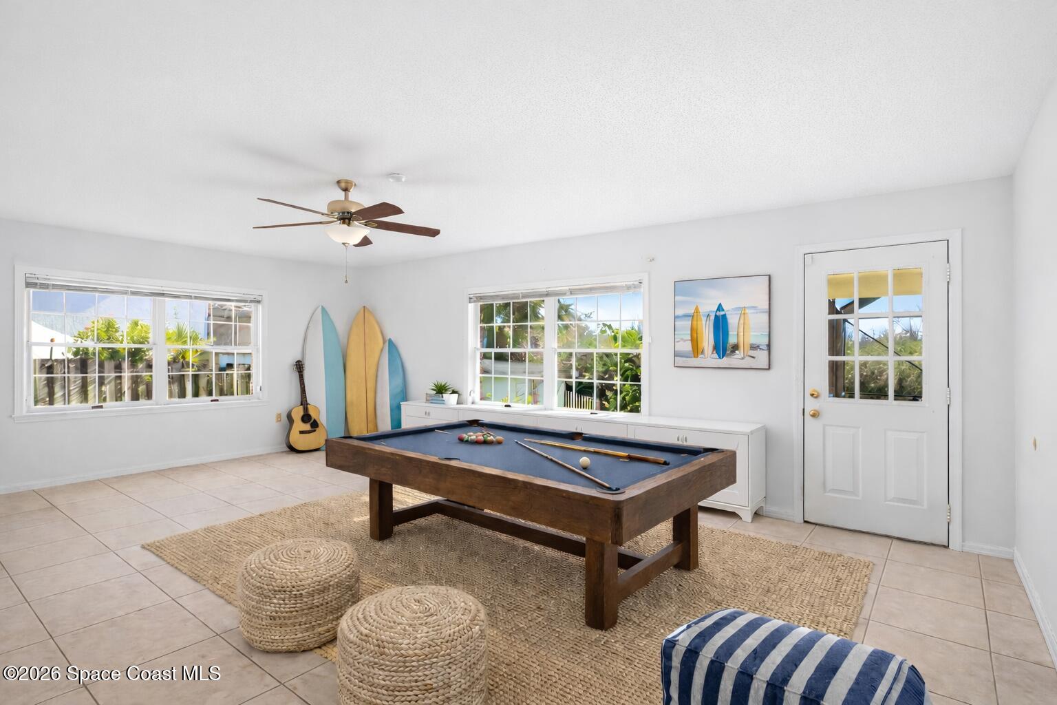 835 Sunswept Road Northeast Palm Bay, FL 32905 - Photo 9 of 36 a living room with furniture a window and gym equipment