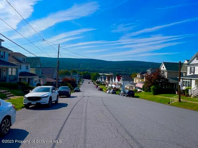 a view of a patio with table and chairs and a big yard