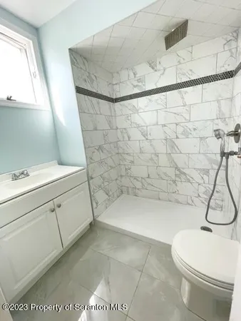 a bathroom with a toilet and a shower