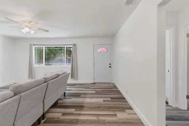 a view of entryway and hall with wooden floor