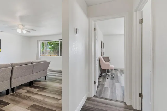 a room with couch mirror and a window