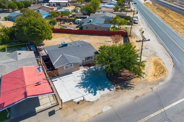 an aerial view of a house with a yard