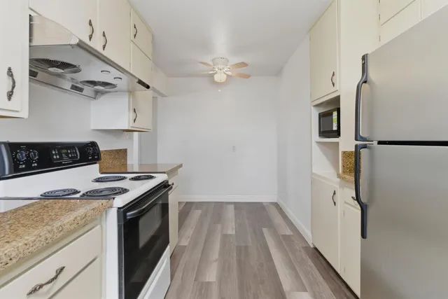 a kitchen with stainless steel appliances a stove a sink and a refrigerator