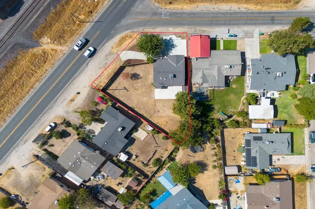 an aerial view of residential houses with outdoor space