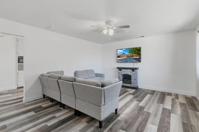 a living room with furniture a fireplace and a flat screen tv