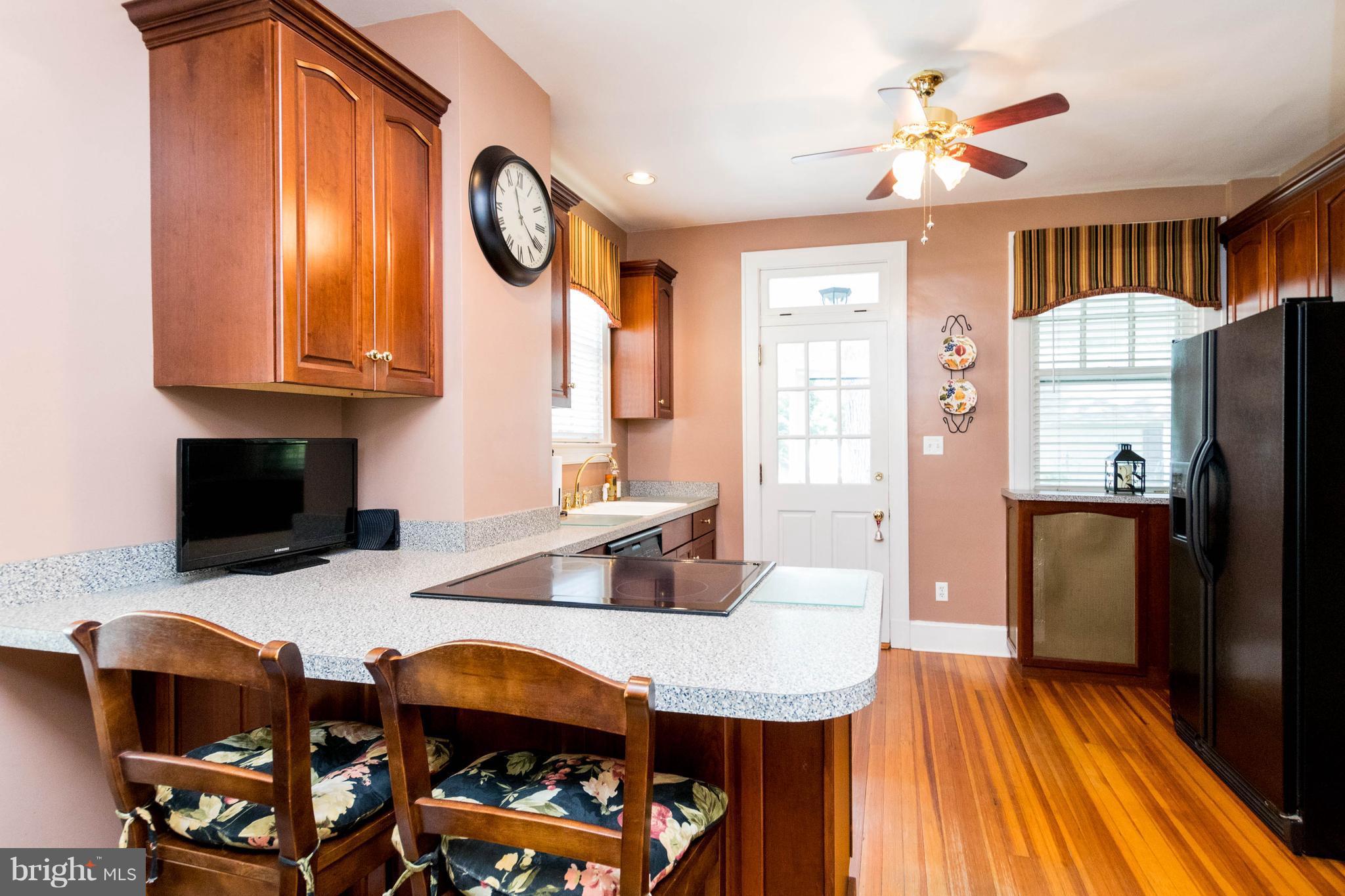 423 South Rolling Road Baltimore, MD 21228 - Photo 13 of 30 a view of dining room and kitchen with furniture wooden floor and window