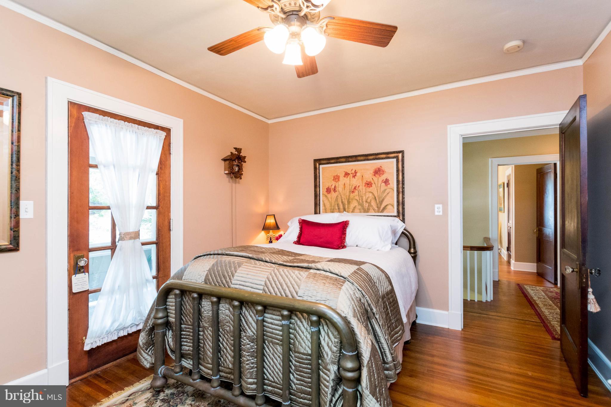 423 South Rolling Road Baltimore, MD 21228 - Photo 18 of 30 a bedroom with a bed and a chandelier