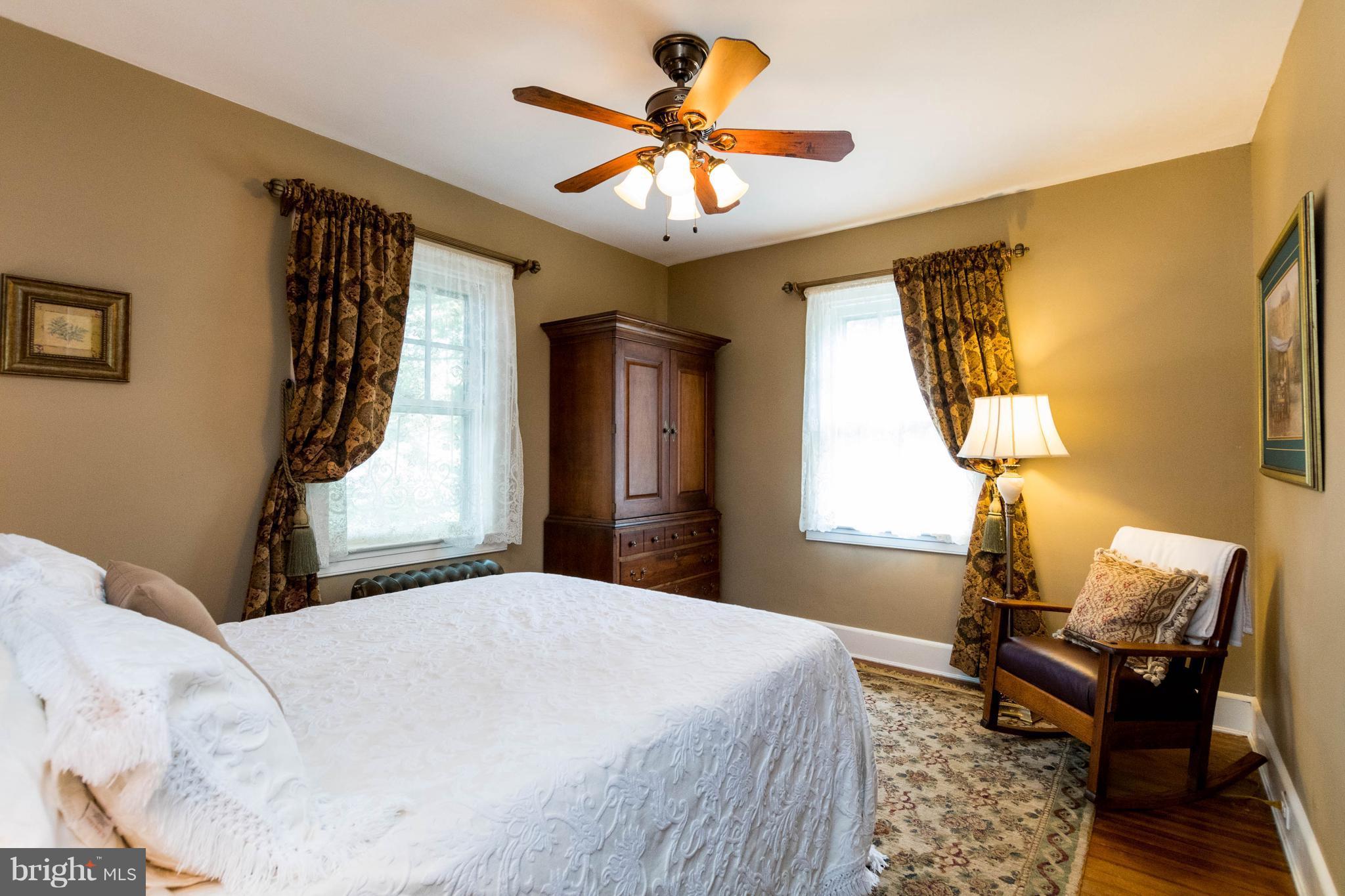423 South Rolling Road Baltimore, MD 21228 - Photo 21 of 30 a bedroom with a bed and a chandelier
