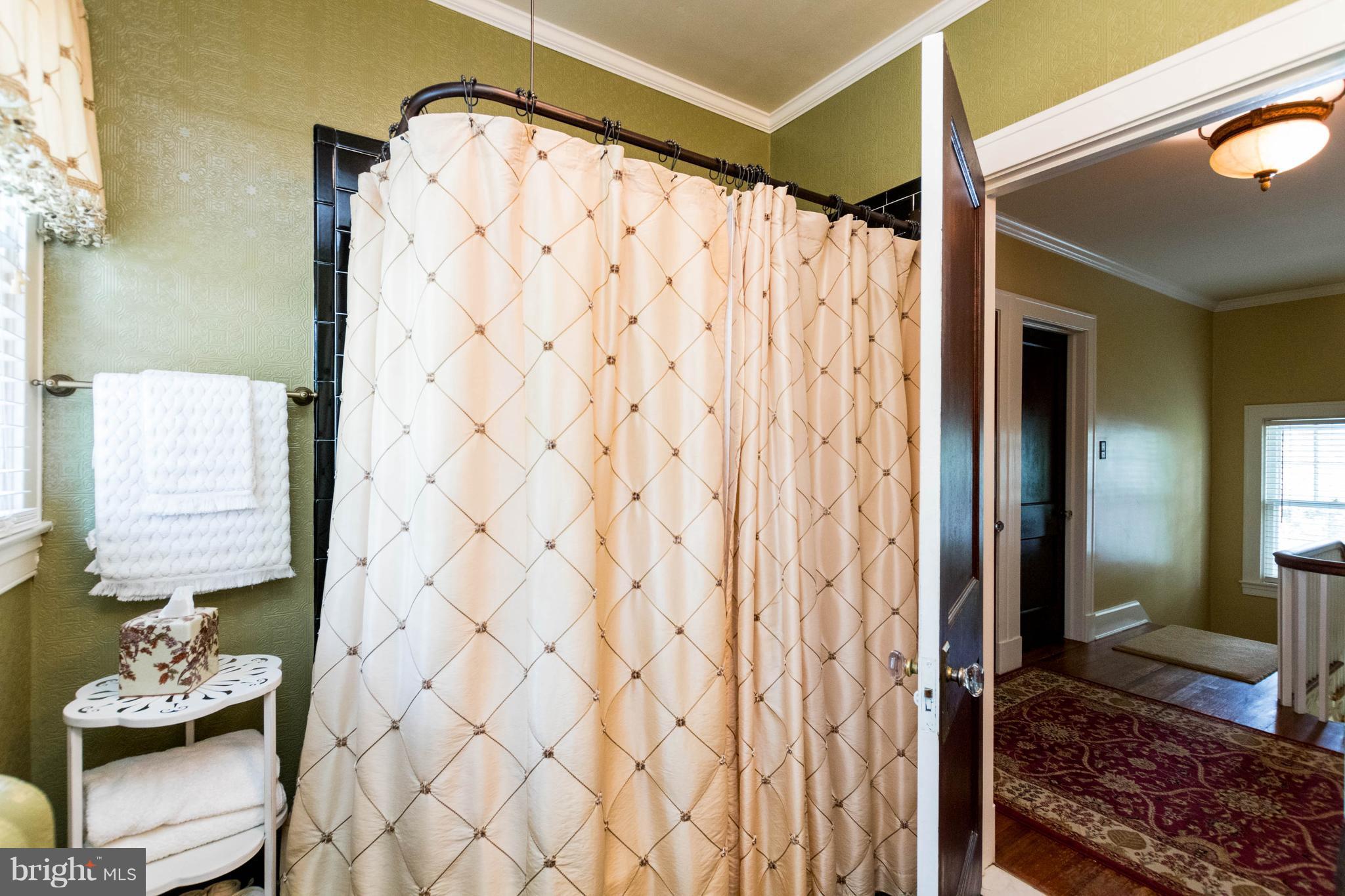 423 South Rolling Road Baltimore, MD 21228 - Photo 24 of 30 a bathroom with a shower curtain and a sink