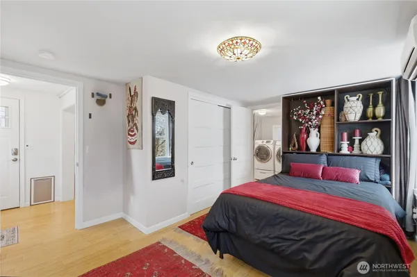 a bedroom with a bed and a lamp on dresser