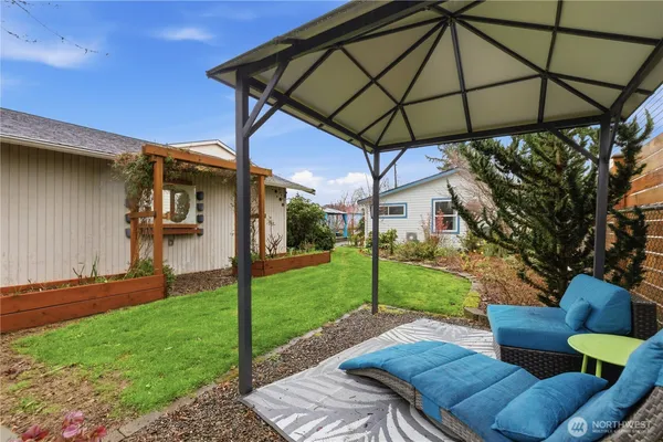 a house is sitting in middle od the grass