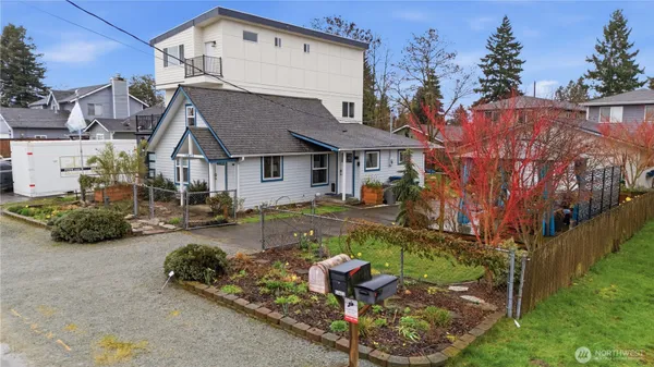 an aerial view of multiple houses with a yard