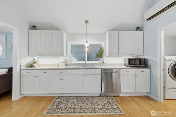 a kitchen with granite countertop white cabinets and white appliances