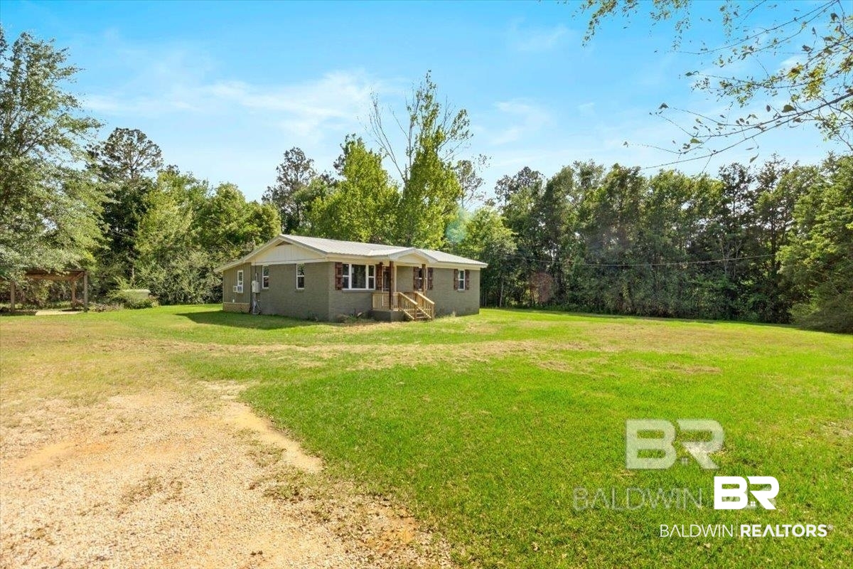 29397 Loper Road Loxley, AL 36551 - Photo 5 of 22 View of grassy yard with view of scattered trees